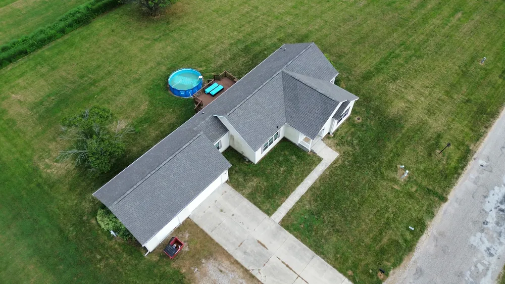 Completed asphalt shingle roof replacement, aerial view
