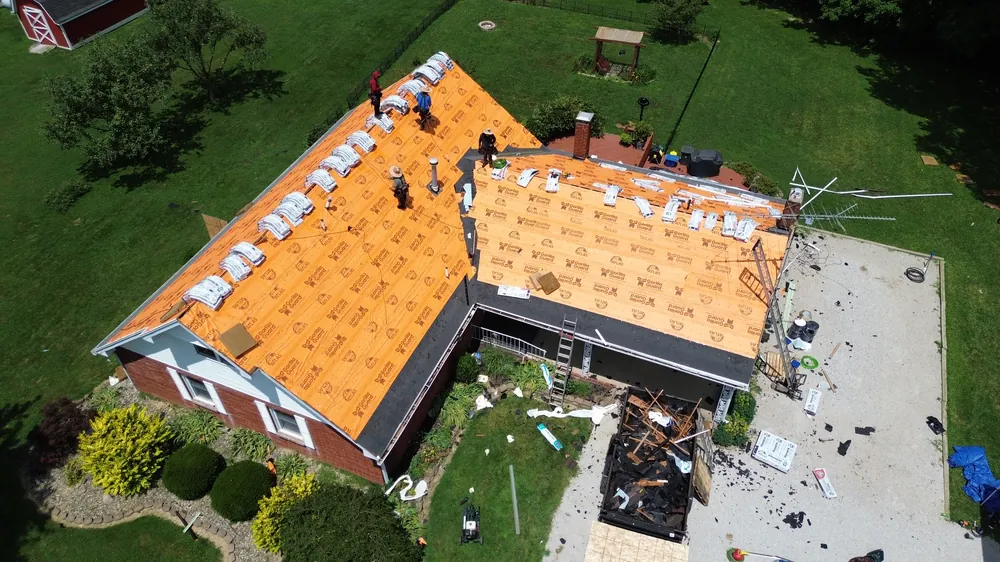 Roof replacement in progress with the crew on site